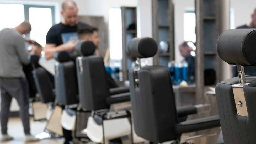 An offender having his hair cut at category C prison HMP Five Wells in Wellingborough