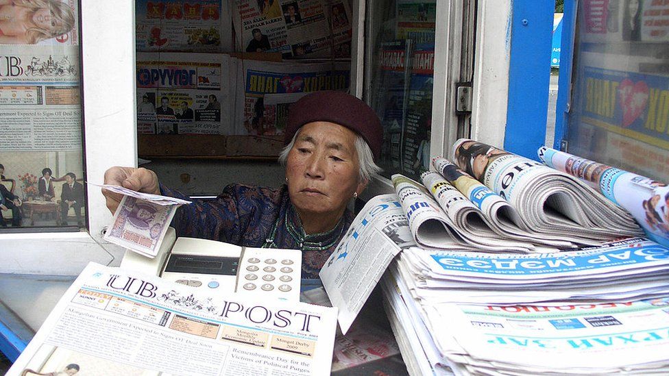 A Mongolian vendor sells newspapers in Ulaanbaatar
