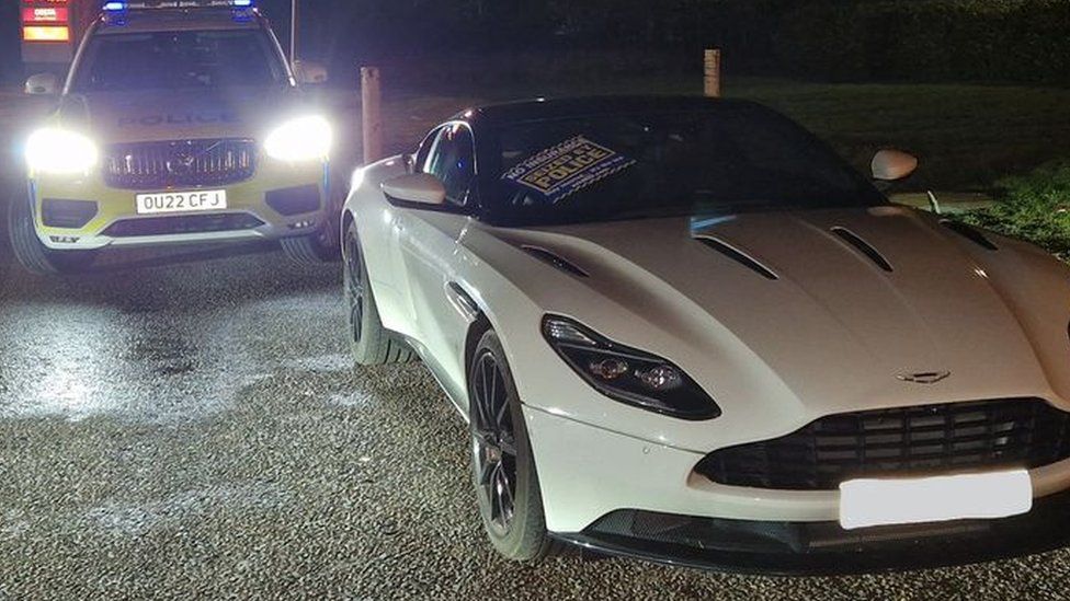 Aston Martin and a police car by the A14 in Cambridgeshire