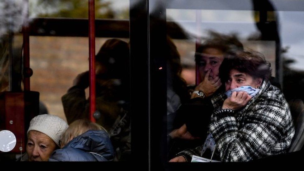 Synagogue visitors react in a bus after surviving a shooting at a synagogue in Halle, Germany