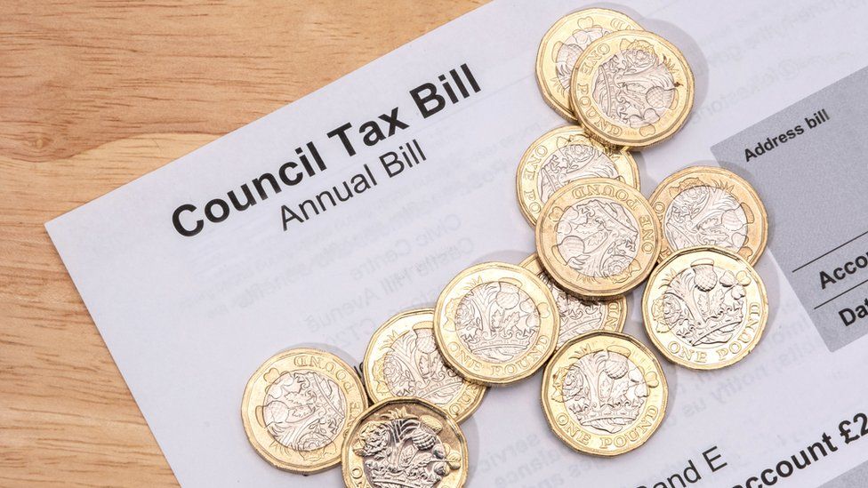 A council tax bill with pound coins on it