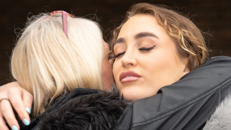Georgia Harrison hugs an unknown woman outside court after the sentencing of Stephen Bear