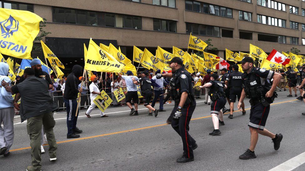 Police officers intervene a conflict as Pro-Khalistan supporters gather for a demonstration in front of the Consulate General of India in Toronto, Ontario, Canada on July 8, 2023. Pro-India counter protestors also gathered outside the Indian Consulate for a counter protest.