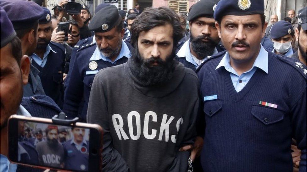 Zahir Jaffer, convicted of murdering his friend Noor Muqaddam, the daughter of a former ambassador, is escorted by police as he leaves a court after the verdict in Islamabad, Pakistan, 24 February 2022.