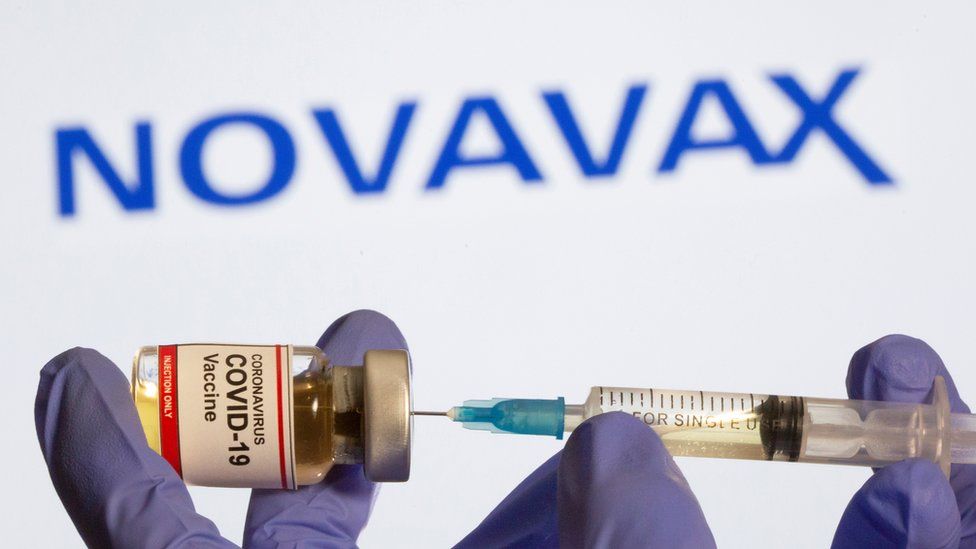 Novavax vial an syringe being held