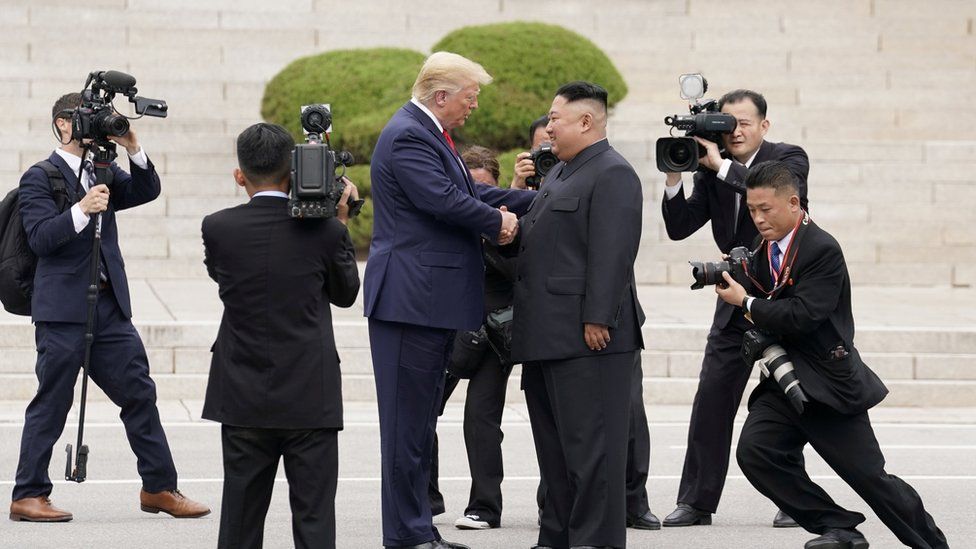 US President Donald Trump meets North Korean leader Kim Jong-un at the demilitarised zone separating the two Koreas, in Panmunjom, South Korea, 30 June, 2019