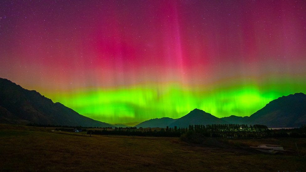 Pink and green lights of the Aurora Australis over Jacks Point, Queenstown, New Zealand