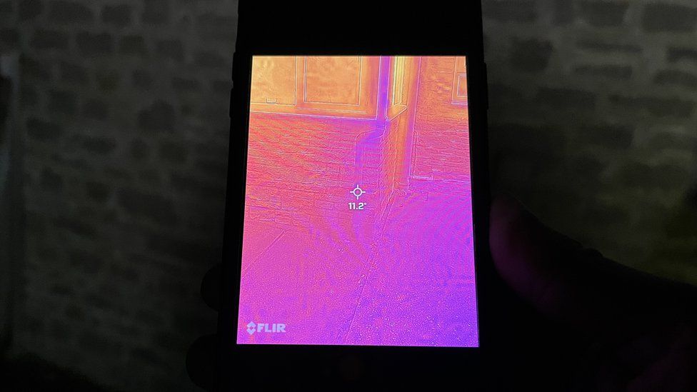 a thermal image of a home shown on a mobile phone screen