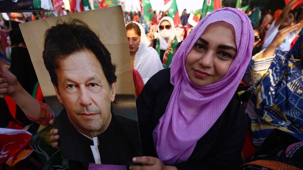 A supporter of Imran Khan holds a poster with his portrait at a rally in Karachi in support of the former Pakistani prime minister.