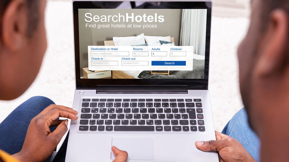 Couple booking a hotel on a laptop