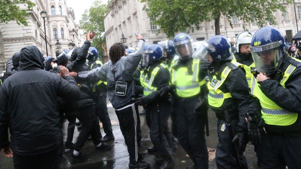 British police intervene the protesters as thousands of people take part in a 'Black Lives Matter' protest at Parliament Square in London,