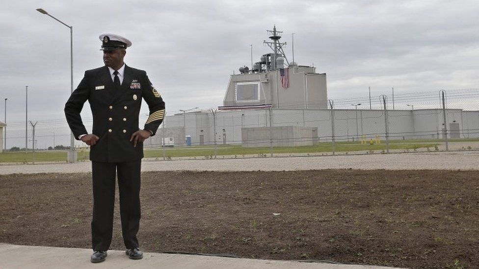 A US Navy officer alongside the AEGIS Command Center building prior to the official inauguration ceremony of the land-based missile defence station (12 May 2016)
