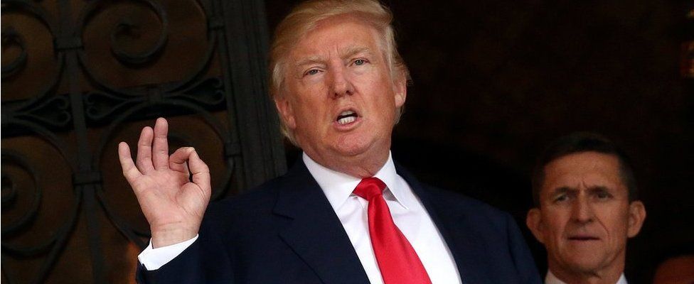 U.S. President-elect Donald Trump talks to members of the media as retired U.S. Army Lieutenant General Michael Flynn stands next to him at Mar-a-Lago estate in Palm Beach, Florida, U.S., December 21, 2016