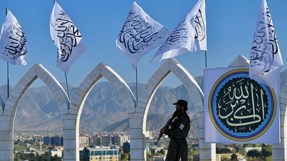 A Taliban fighter stands guard at the venue for a flag hoisting ceremony of the Taliban flag on the Wazir Akbar Khan hill in Kabul on March 31, 2022