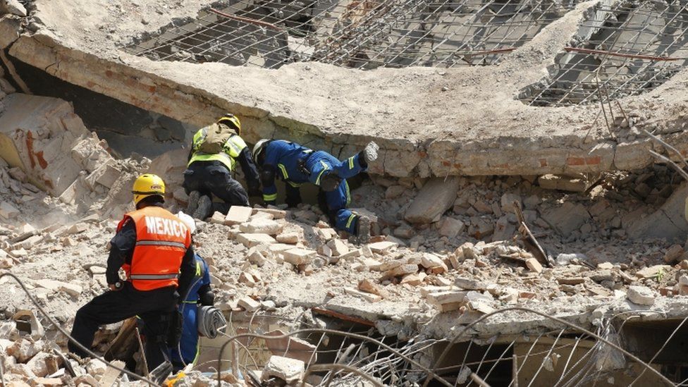 Rescuers and army workers search in rubble in Juchitan