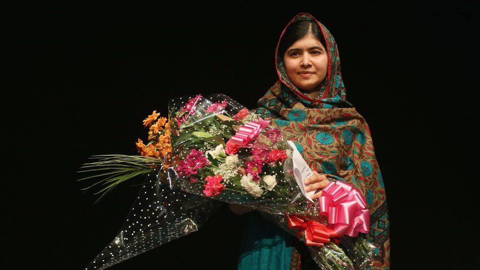 Malala Yousafzai photographed holding a bouquet of flowers on the day she was announced as a Nobel Laureate, 2014