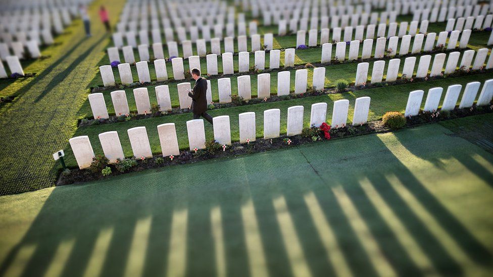 Visitors walk amongst rows of headstones at Tyne Cot Commonwealth War Graves Commission cemetery on March 24 2014 in Passchendaele, Belgium.