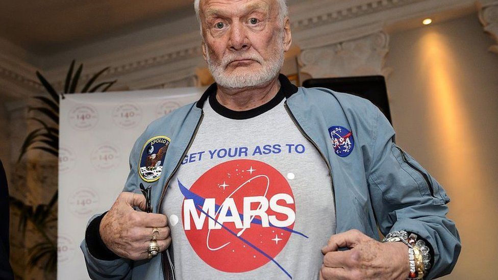 Buzz Aldrin shows off his t-shirt highlighting his campaign for human exploration of Mars