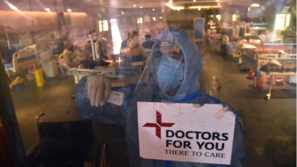 A doctor wearing Personal Protective Equipment (PPE) inside a COVID-19 care center and isolation ward facility near a Hospital in New Delhi, India, 10 May 2021