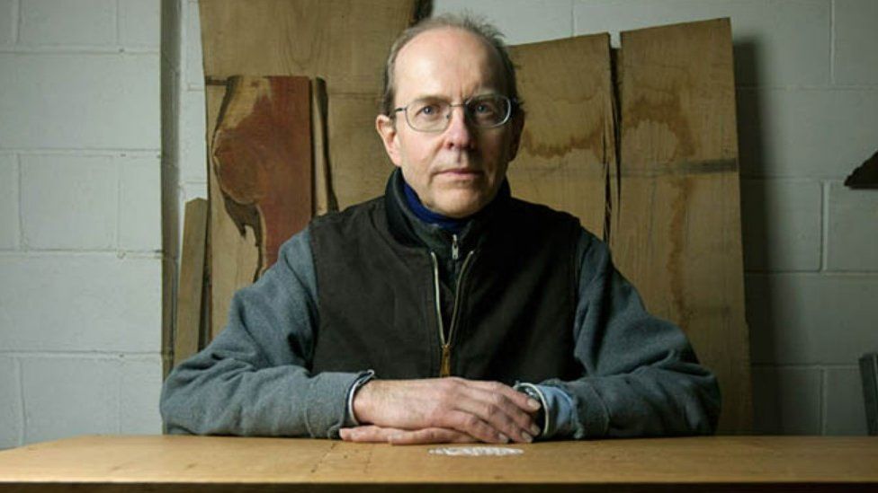 Michael Ibsen with the coffin he built