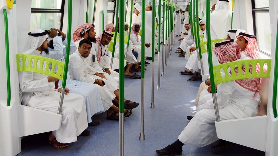 Saudi Arabian men ride on the newly-opened Holy Sites metro light rail in the western Saudi city of Mecca on November 2, 2010.