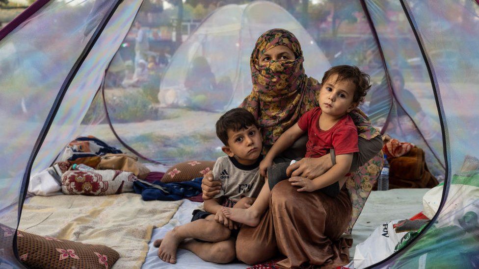 Farzia, 28, who lost her husband in Baghlan one week ago to fighting by the Taliban sits with her children, Subhan, 5, and Ismael ,2, in a tent at a makeshift IDP camp in Kabul