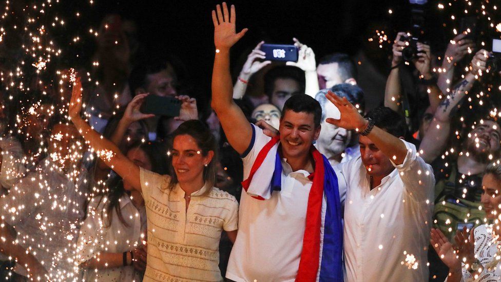Santiago Peña (centre) celebrates at the Colorado Party headquarters in Asunción, Paraguay. Photo: 30 April 2023