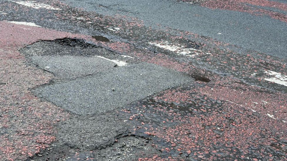A pothole by a car park exit at the Market Street/High Street intersection in Chorley town centre