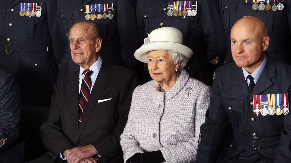 Prince Philip and the Queen pose for a photo during a visit to RAF Lossiemouth on their 67th wedding anniversary in 2014