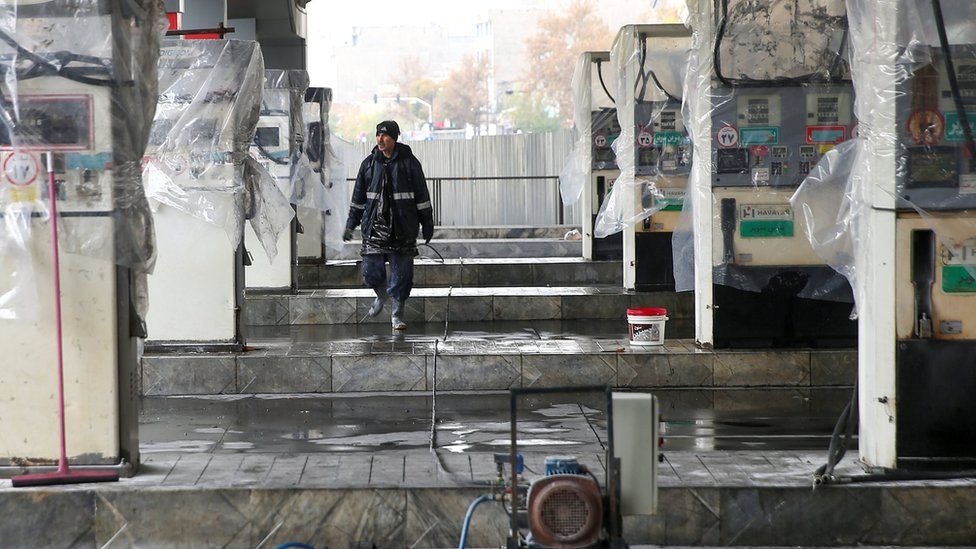 A man walks near the remains of petrol pump stands, during protests against increased fuel prices, in Tehran, Iran, 20 November, 2019.