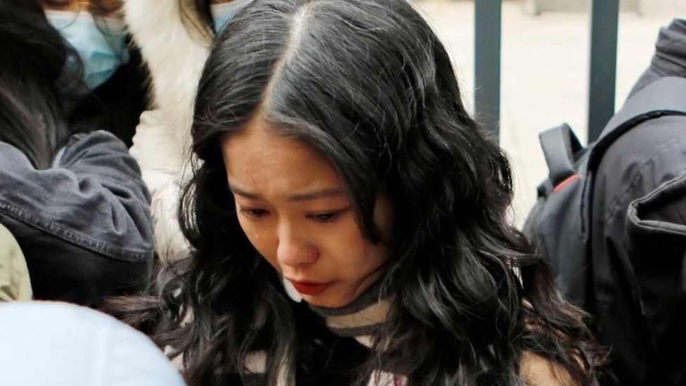 Zhou Xiaoxuan, also known by her online name Xianzi, weeps as she arrives at a court for a sexual harassment case involving a Chinese state TV host, in Beijing, China December 2, 2020.