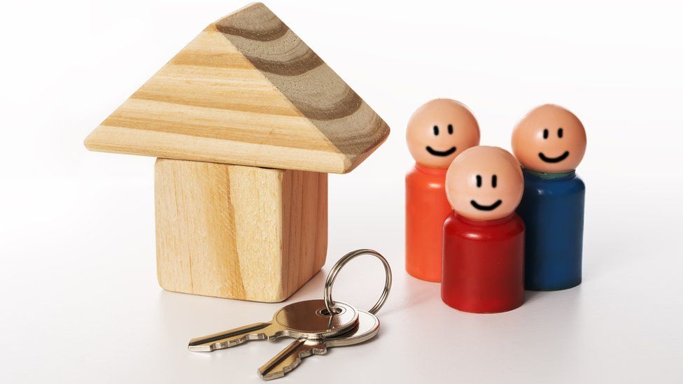 Model of house, keys and family
