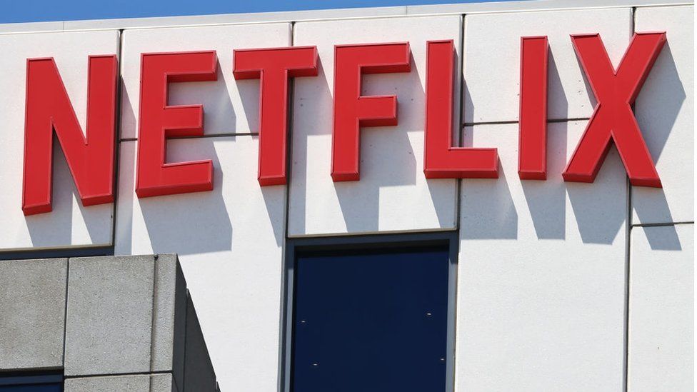 The Netflix logo is displayed at Netflix offices on July 19, 2023 in Los Angeles, California. Members of SAG-AFTRA, Hollywood's largest union which represents actors and other media professionals, have joined striking WGA (Writers Guild of America) workers in the first joint walkout against the studios since 1960. The strike could shut down Hollywood productions completely with writers in the third month of their strike against the Hollywood studios. Netflix reported second quarter earnings after the closing bell today.