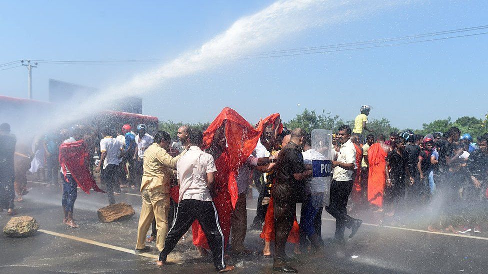 Sri Lankan police use a water cannon to disperse activists and Buddhist during a protest in the southern port city of Hambantota on January 7, 2017