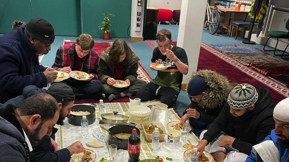Members of the community breaking a fast at an Iftar