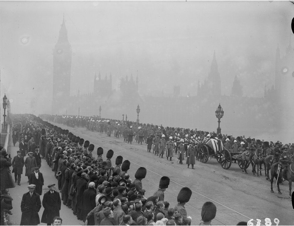 The funeral procession of Earl Haig, the gun carriage bearing his coffin is draped with a Union Jack and soldiers in bearskins line the pavements.