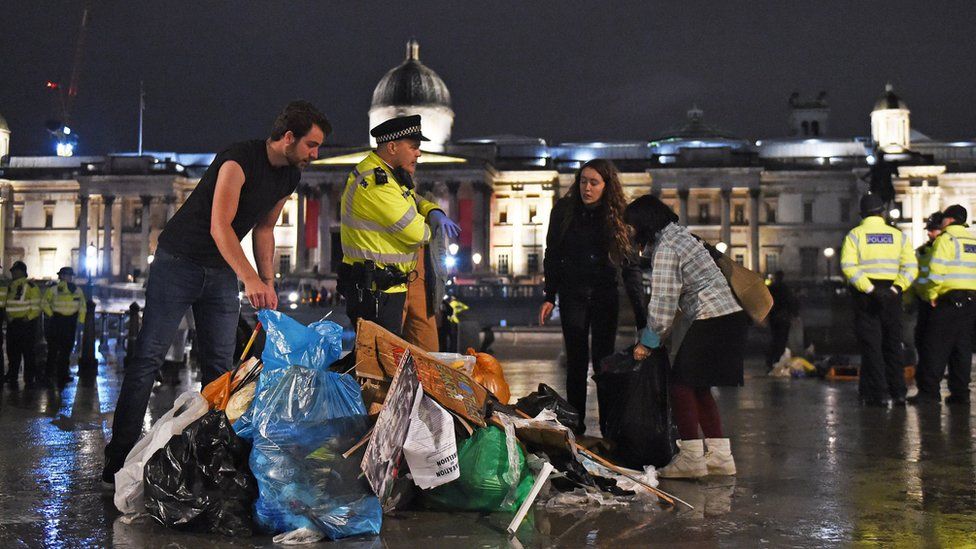 Protesters gather items as police remove Extinction Rebellion protesters from Trafalgar Square
