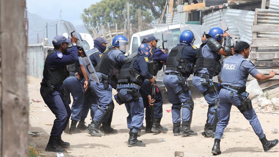 Police reacting during clashes in Phillipi, Cape Town, South Africa - Tuesday 12 December 2023