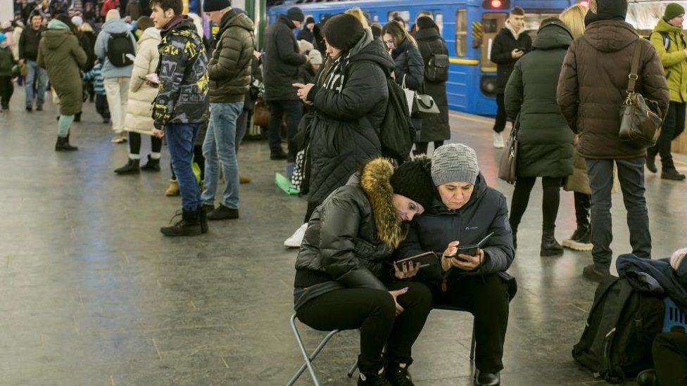 People take shelter in a Kyiv metro station