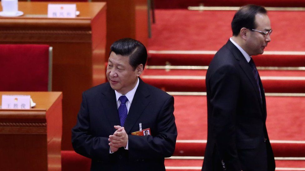 Communist Party Secretary of Chongqing Sun Zhengcai (R) walks behind Chinese President Xi Jinping (L) as they attending the fifth plenary meeting of the National People's Congress at the Great Hall of the People on 15 March 2013 in Beijing, Chin