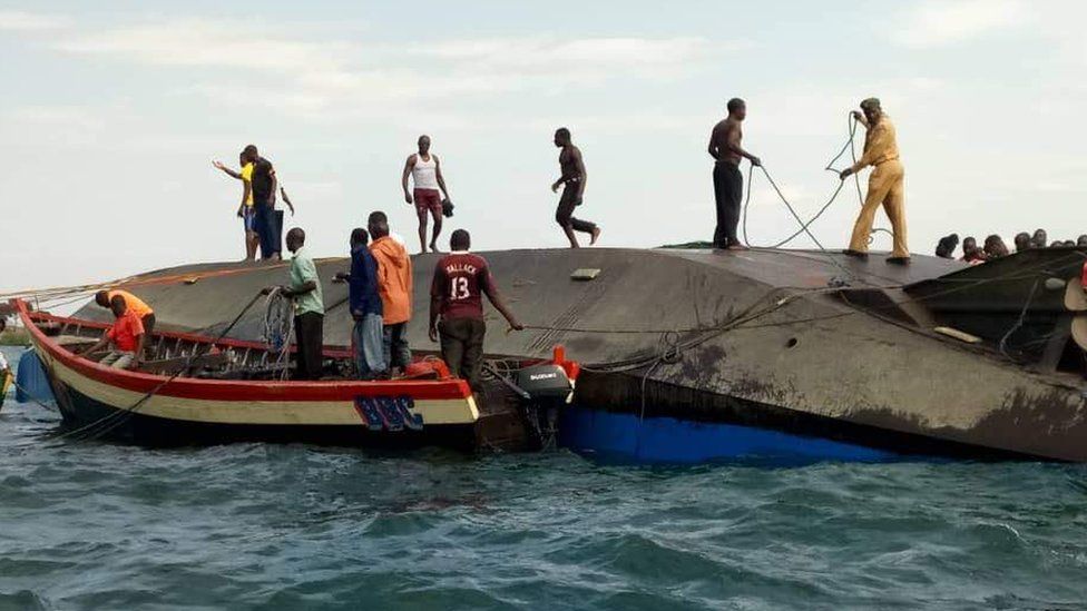 Volunteers work at the scene of a capsizing in Tanzania
