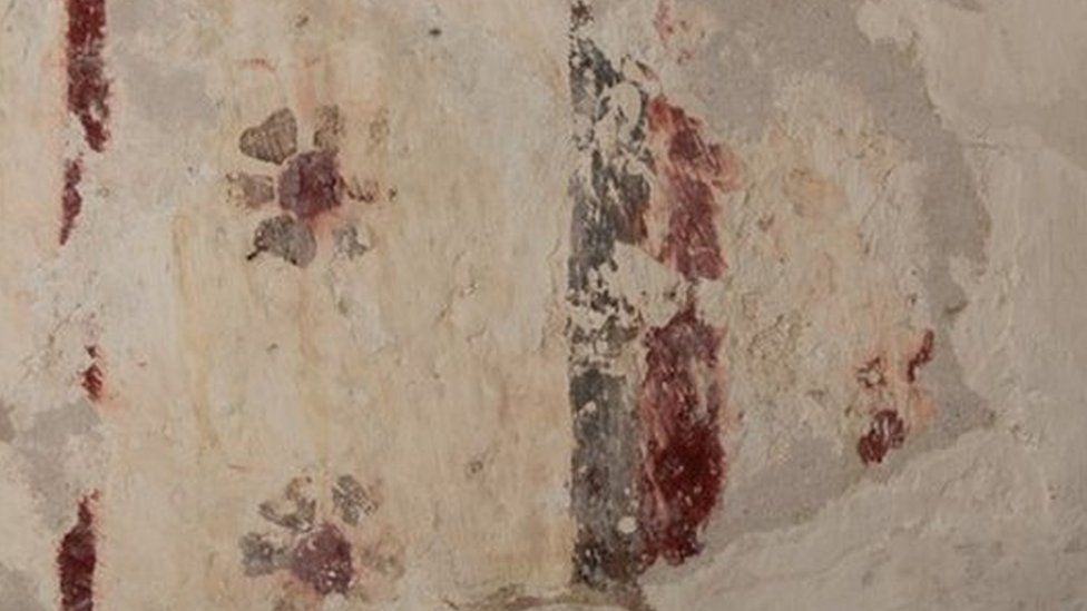 A fragment of the painting showing a border in red and orange ochres