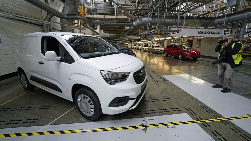 A photographer taking a picture of a new electric van at Vauxhall's plant in Ellesmere Port, Cheshire