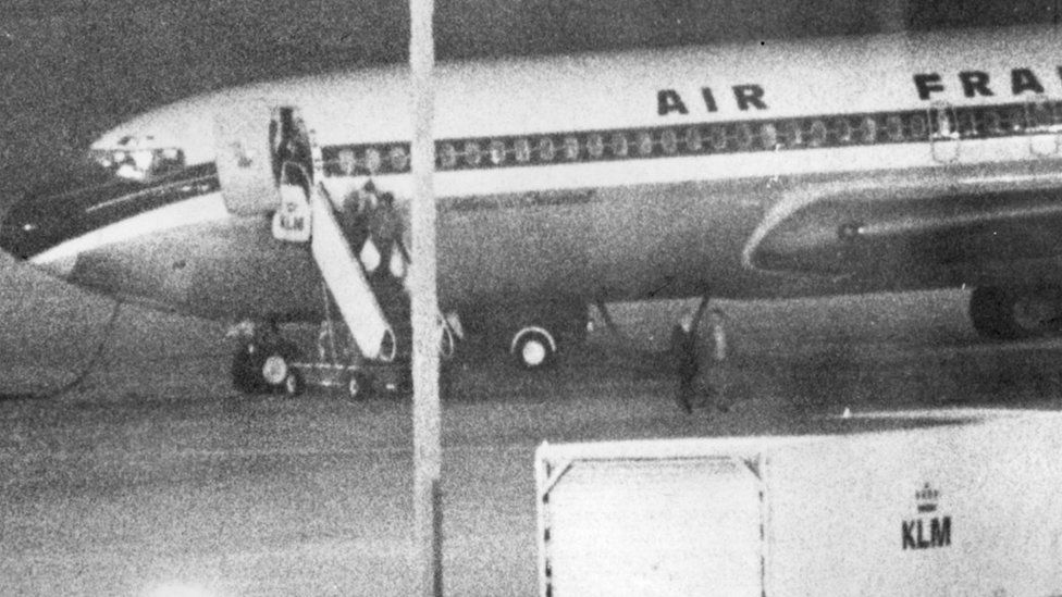 Picture released on September 18, 1974 of JRA member Yatsuka Furuya boarding on an Air France plane, carrying bags, at Amsterdam-Schiphol airport