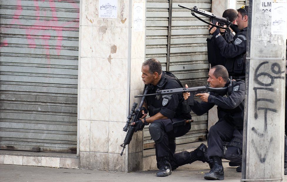Riot agents hold their rifles at an entrance of Vila Cruzeiro shantytown in Rio de Janeiro, Brazil on 25 November, 2010
