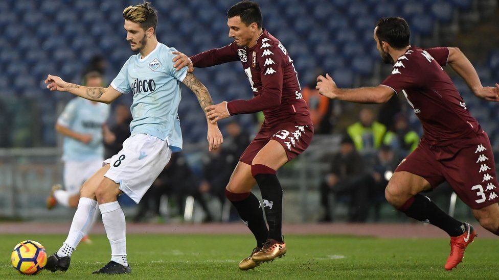 Lazio"s Spanish midfielder Luis Alberto vies for the ball with Torino"s Argentinian defender Nicolas Burdisso during match