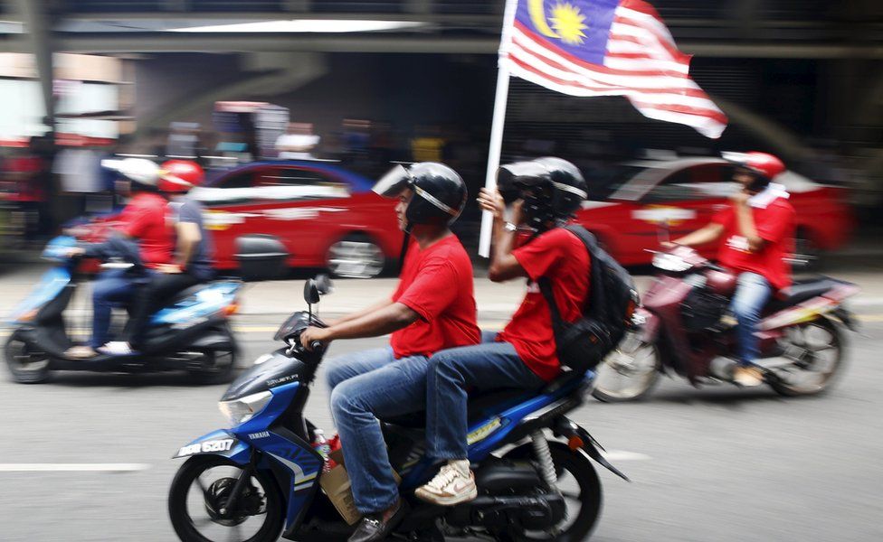 People on a motorbike with a Malaysian flag in KL (16 Sept 2015)