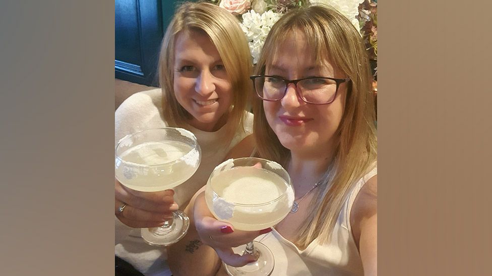 Jen Watts (right) with her sister drinking a margarita