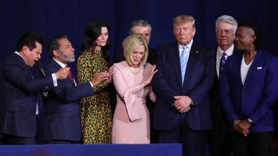 Donald Trump praying with evangelical leaders in January 2020