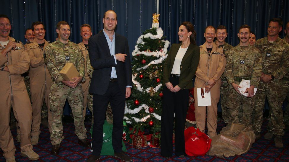 The Duke and Duchess of Cambridge standing by a Christmas tree at RAF Akrotiri base